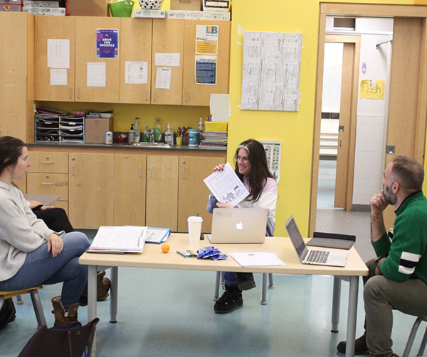 Teachers at Leo Baeck receiving further learning and development around a table.